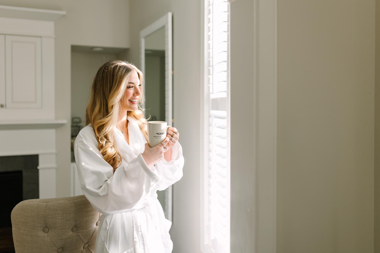 A person in a robe holding a mug